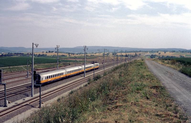 A <i>Lufthansa Airport Express</i> train passes through Kraichtal station, headed for Stuttgart.