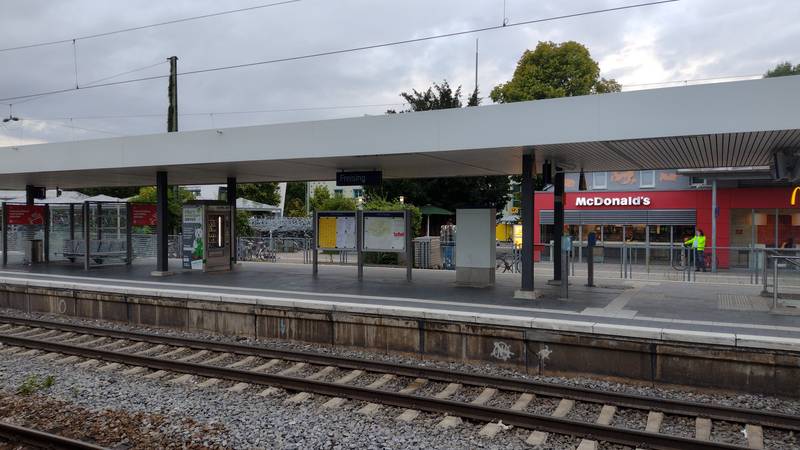 Platform of Freising station, with a McDonald's.