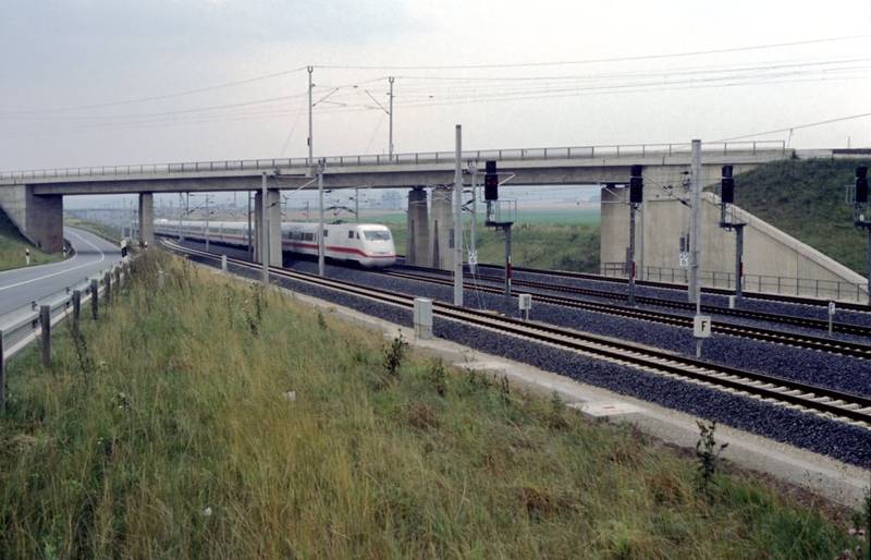 An ICE 1 high-speed train passes through the station of Escherde, headed north.