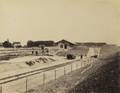 165789, Gezicht op het in aanleg zijnde emplacement, met goederenloods en dijkcoupure, van het S.S.-station Geertruidenberg te Geertruidenberg., Hameter, J.G., fotograaf