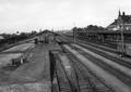 154841, Gezicht op het emplacement van het N.S.-station Geldermalsen te Geldermalsen met het laadperron en de goederenloods en geheel rechts een deel van het stationsgebouw., Nederlandse Spoorwegen, fotograaf