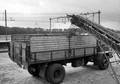 849052, Afbeelding van het overladen van steenkool uit een zelflosser op de laad- en losplaats van het N.S.-station Harderwijk met behulp van een jacobsladder., Nederlandse Spoorwegen, fotograaf