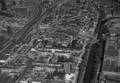 120032, Luchtfoto van de Stationswijk en de Daalsebuurt te Utrecht, uit het zuidoosten. Links het Centraal Station (Stationsplein), in het midden het Leidseveer en rechts de Catharijnesingel en de Stadsbuitengracht., KLM Aerocarto, fotograaf