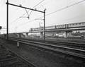 76625, Gezicht op de ongelijkvloerse kruising van de spoorlijn Utrecht-Rotterdam (boven) en Utrecht-Amsterdam (achtergrond) aan de noordzijde van het Centraal Station te Utrecht. Op de achtergrond de lijnwerkplaats van de N.S., Gemeentearchief Utrecht, fotograaf